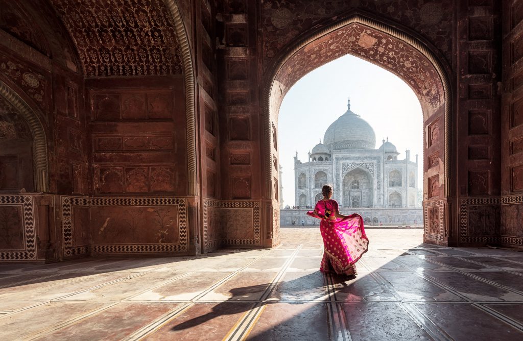 Woman in red sareesari in the Taj Mahal, Agra, Uttar Pradesh, India